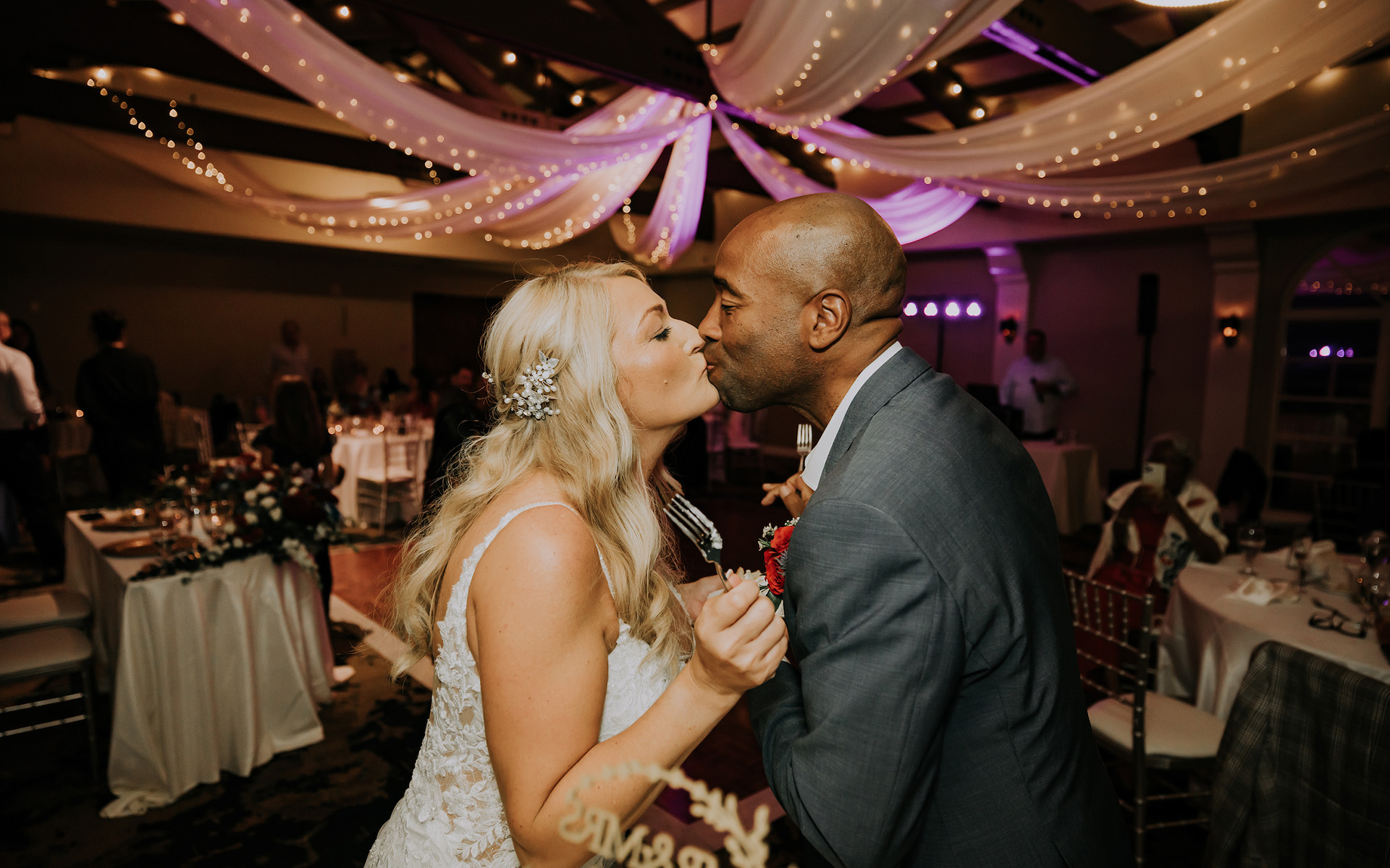 Interracial couple kissing on their wedding day